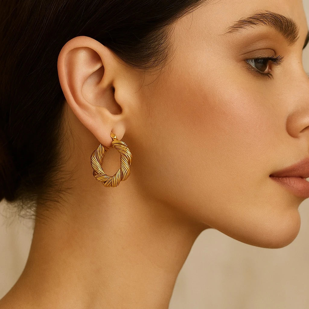 Model wearing PaulaB Twisted 18k gold-plated copper hoop earrings, elegant French inspired design with a polished finish, photographed for PaulaB Jewellery Australia, New Zealand & UK.