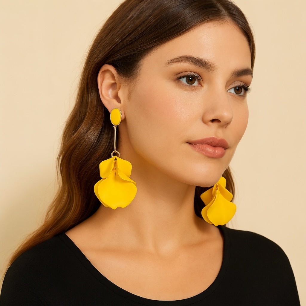 Woman wearing yellow floral earrings against a beige background
