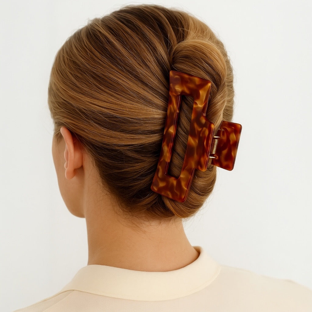 Model wearing amber glaze hair claw clip in French Twist updo.