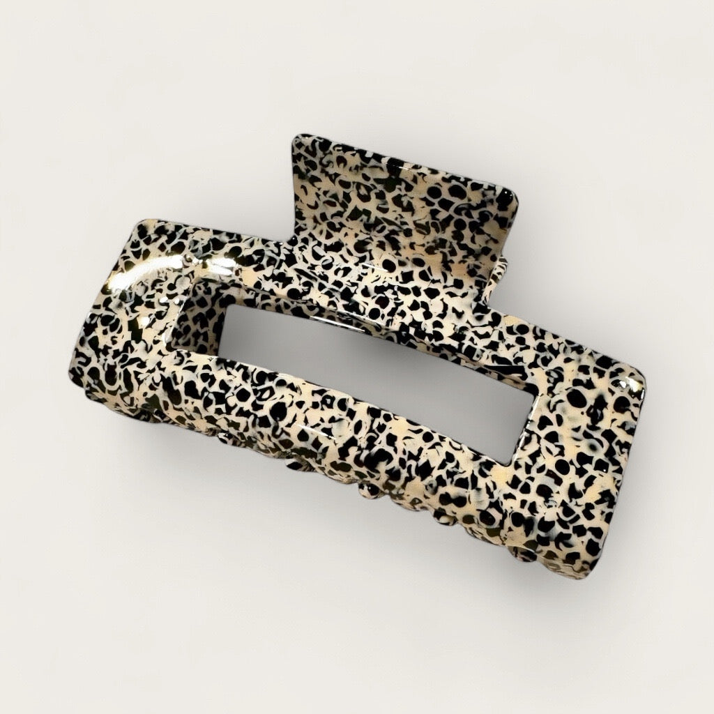 Ivory Eclipse hair claw clip with black speckled animal print on cream background.
