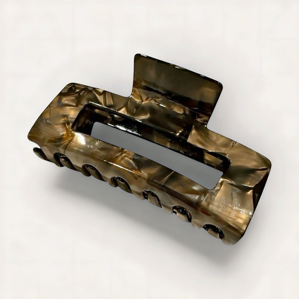 Midnight marble hair claw clip in glossy espresso and pearl tones on soft white, grey background.