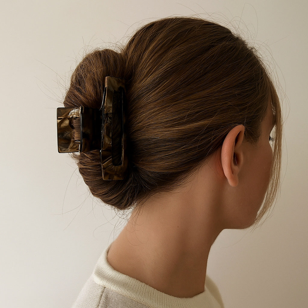 Model wearing midnight marble hair claw clip in twisted bun hairstyle.