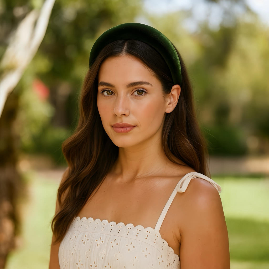 Model styling a green velvet headband in a sunny park summer outfit.