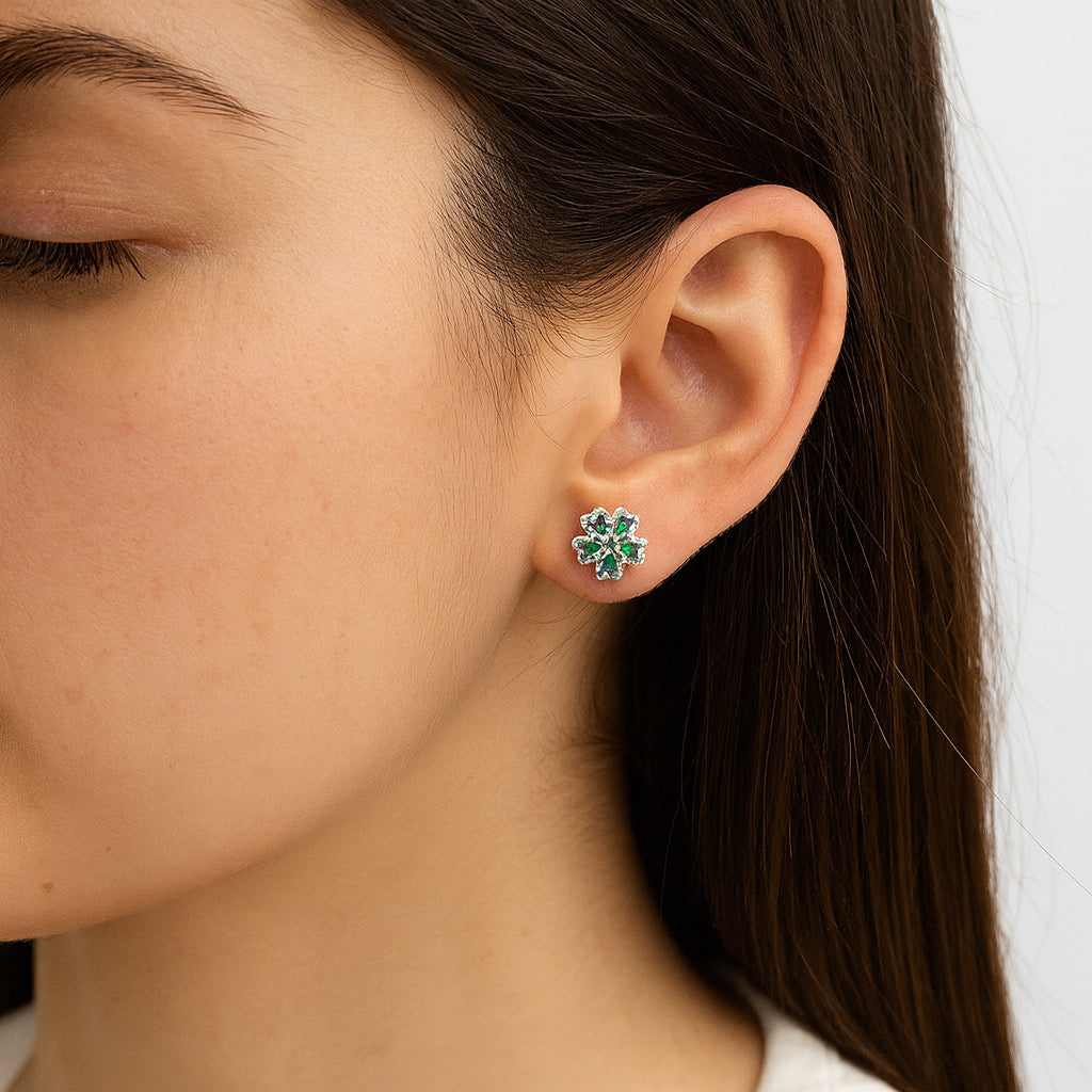 Model wearing rhodium-plated sterling silver floral stud earrings with green gemstones - PaulaB Jewellery Sydney & New Zealand.