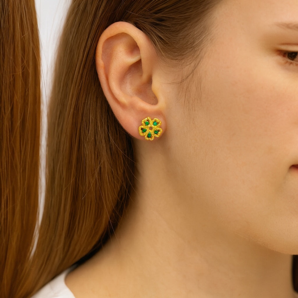 Model wearing gold-plated sterling silver floral stud earrings with green gemstones - PaulaB Jewellery Australia & New Zealand.