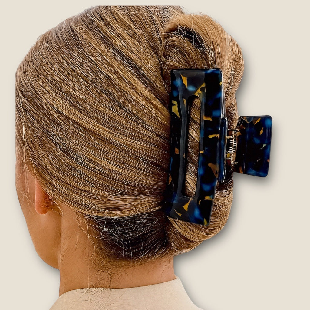 Blonde model wearing Ocean Noir hair claw clip in French twist hairstyle