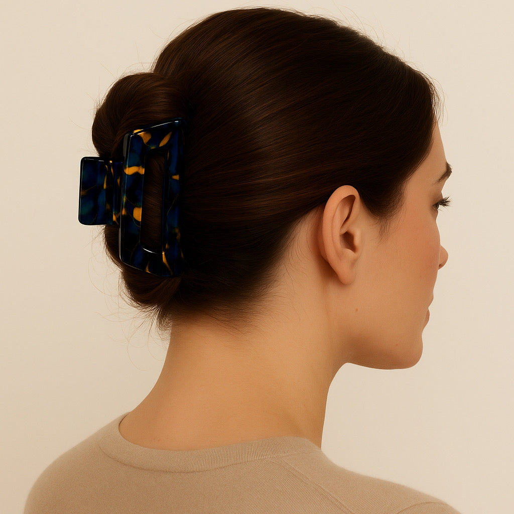 Brunette model wearing Ocean Noir hair claw clip in sculpted French twist updo