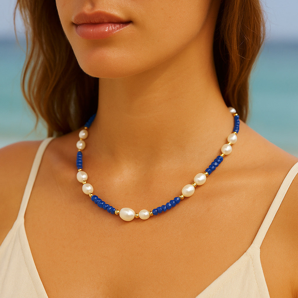 PaulaB luxury necklace with freshwater pearls and natural blue stones styled on model at the beach, 18k gold plated accents — Australia fashion jewellery