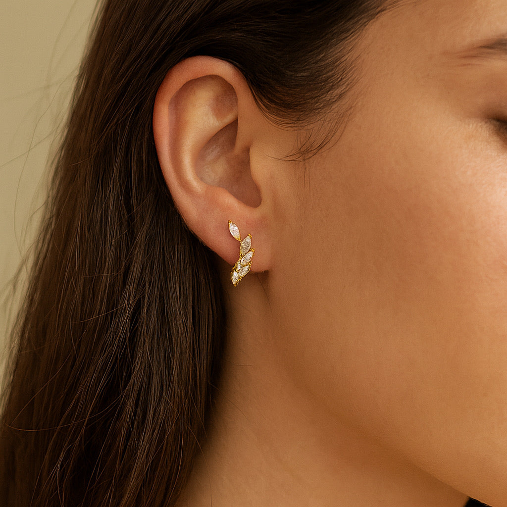 Model wearing PaulaB 14k gold plated sterling silver earrings. close up shot - Sydney jewellery boutique.