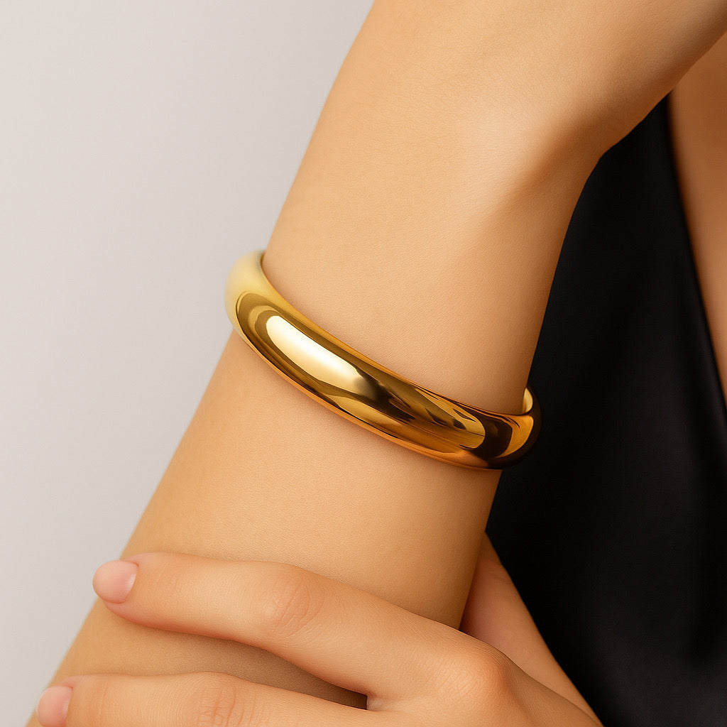 Close-up of PaulaB 18k gold-plated stainless-steel cuff bracelet worn on model wrist- elegant minimal style for modern women.