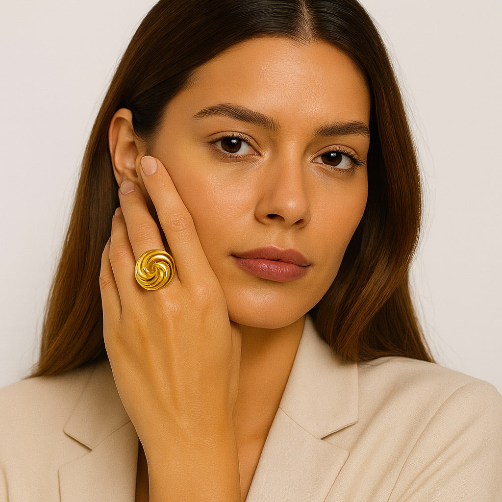 Aurelia Swirl Ring styled on model, statement swirl design in gold tone for modern fashion look.