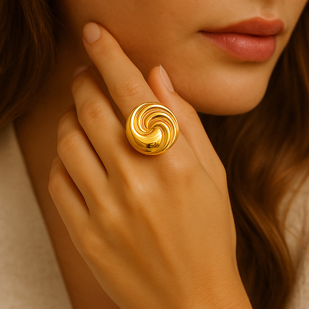 Model wearing Aurelia Swirl Ring, showcasing bold swirl statement design in polished gold finish.