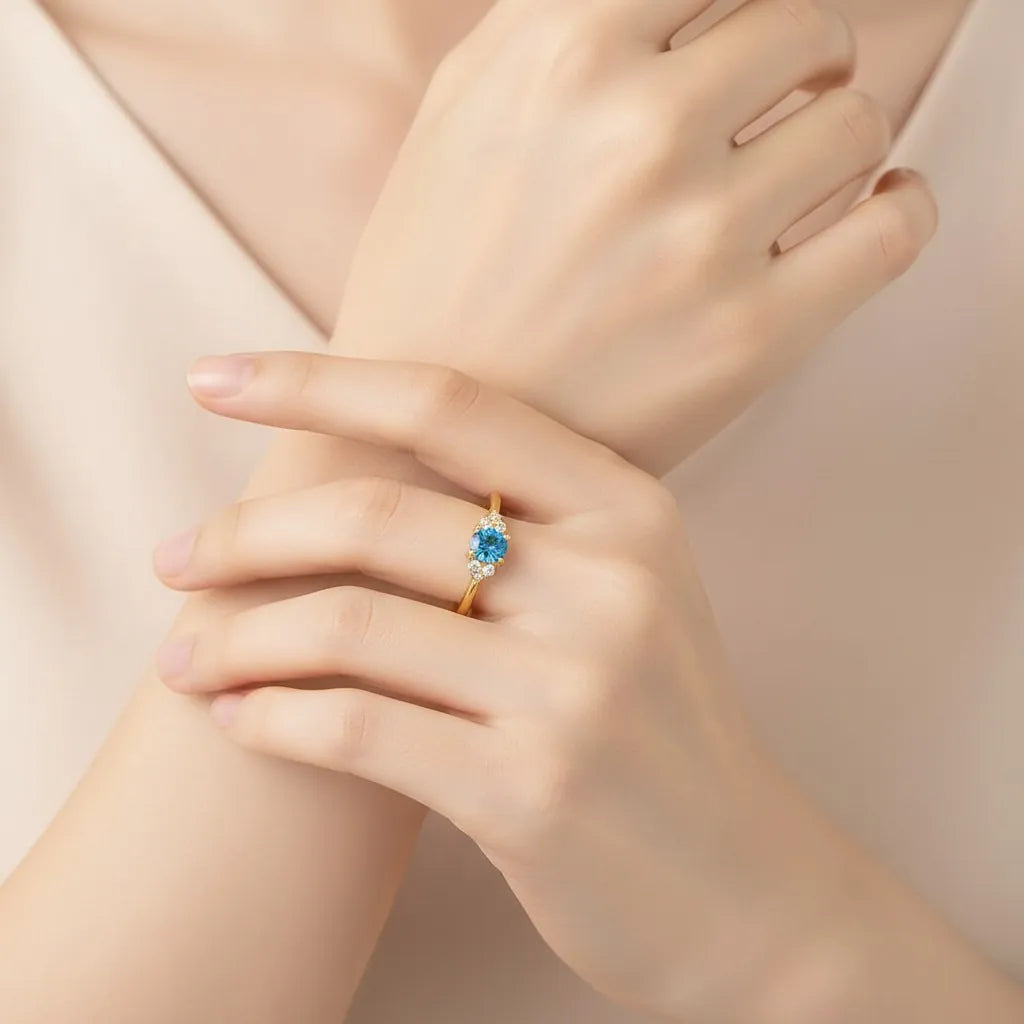 Model wearing PaulaB gold ring with vivid blue gemstone - elegant everyday jewellery for Australia, NZ & UK.