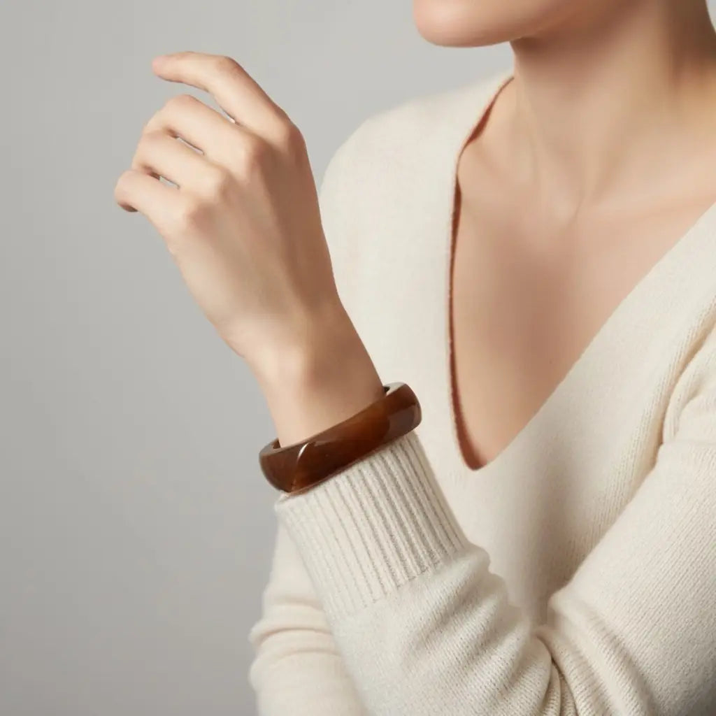 PaulaB Brown Acrylic Resin Bangle styled with ivory knot top - elegant studio lifestyle jewellery image for Australia NZ UK.