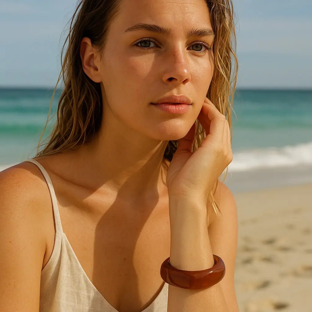 PaulaB Brown Resin Bangle on model hand, beach lifestyle shot, styled in Australia for summer fashion AU NZ UK.