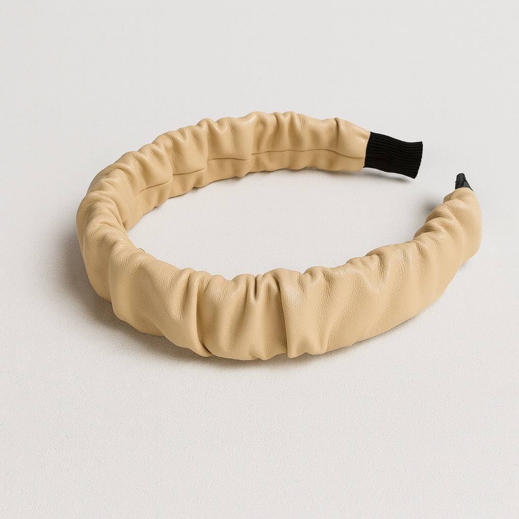 Cream PU leather ruched headband displayed flat on white background