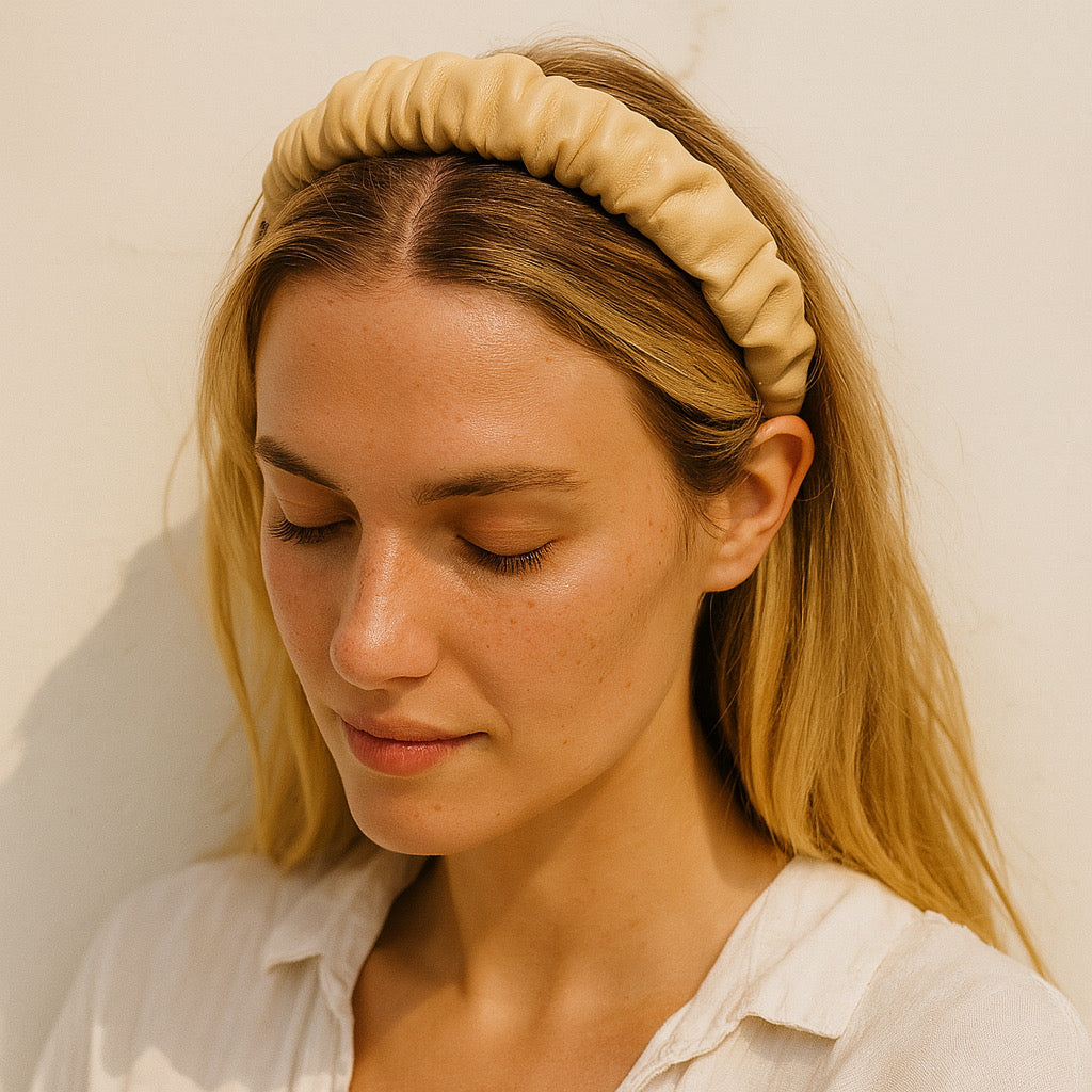Blonde woman wearing cream PU leather ruched headband in outdoor sunlight