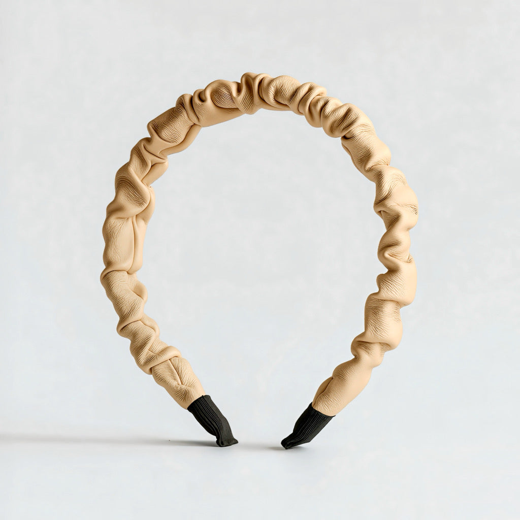 Cream PU leather ruched headband standing upright showing ruched detail