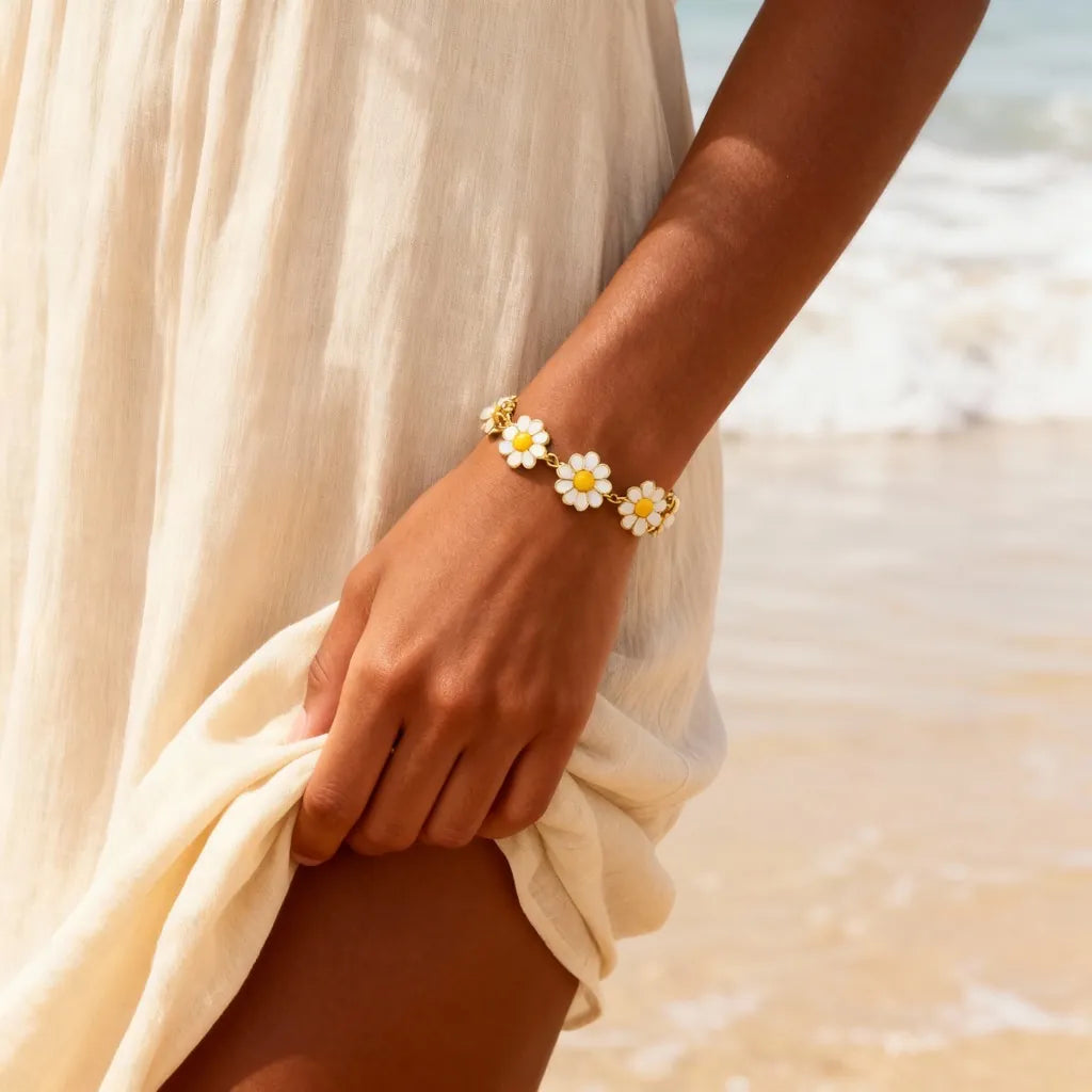 Daisy Bloom Bracelet by PaulaB worn at the beach - floral gold bracelet for women, summer jewellery AU NZ UK.