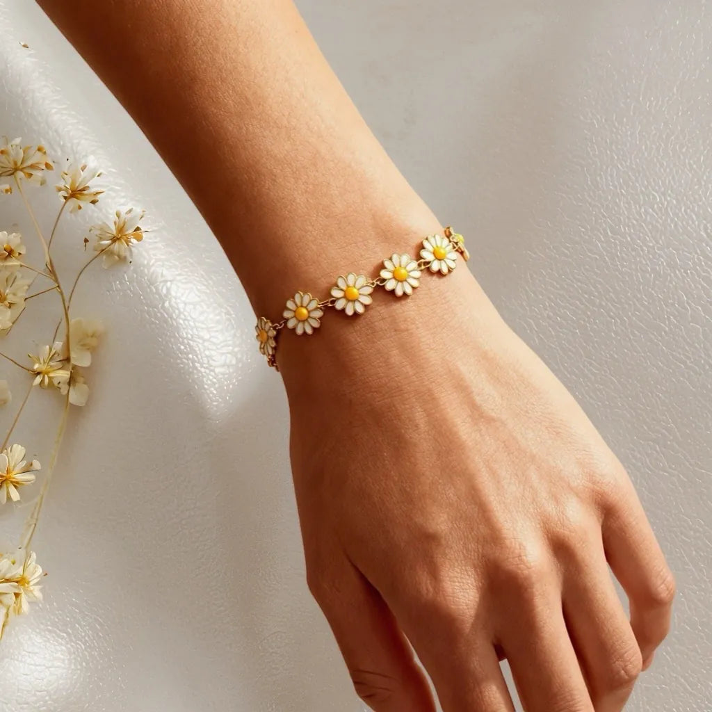 PaulaB Daisy Bloom Bracelet worn on wrist - gold daisy flower bracelet lifestyle close-up, natural lighting, women's jewellery Australia New Zealand UK.