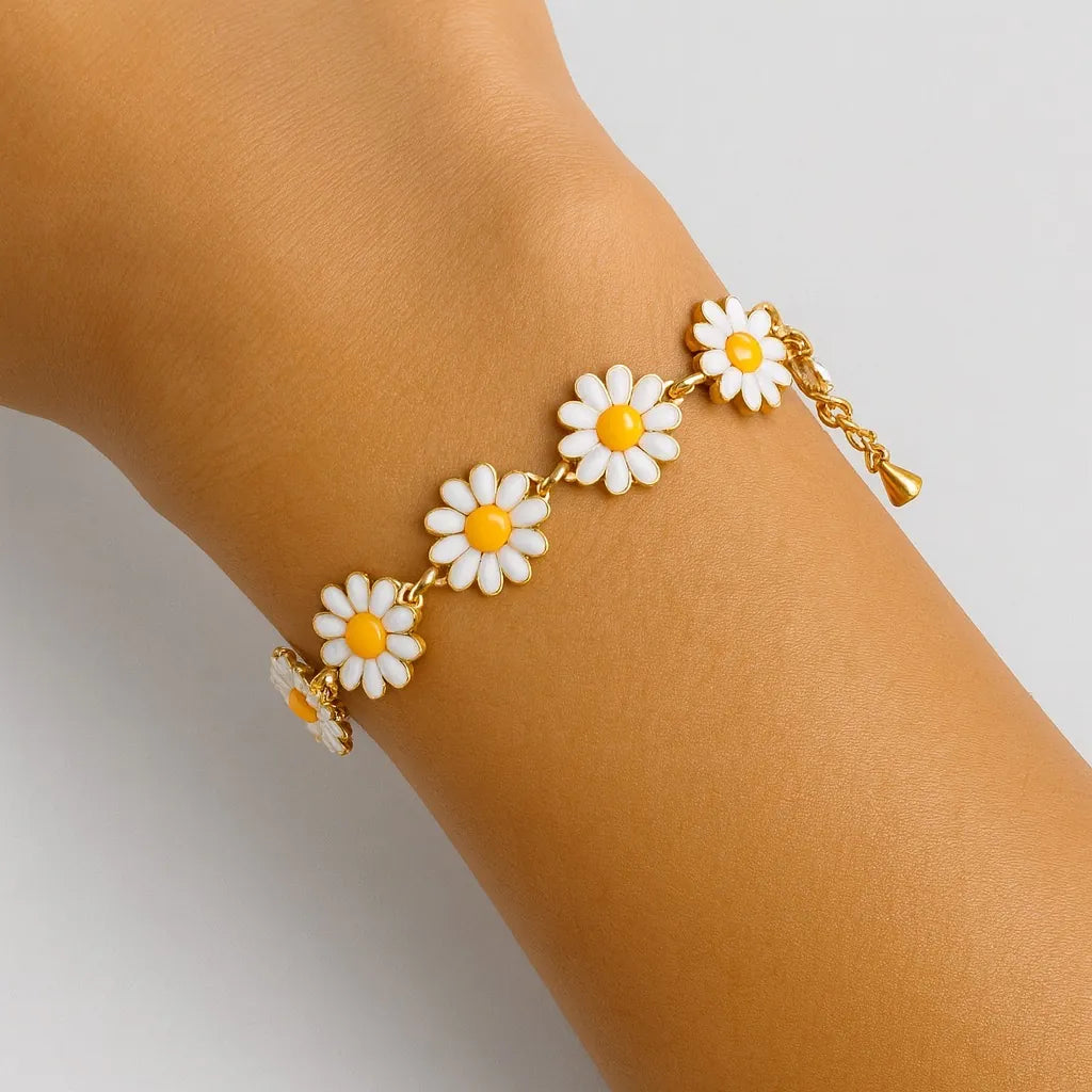 PaulaB Daisy Bloom Bracelet on wrist, gold daisy charm bracelet for women, close-up product detail, Australia New Zealand UK jewellery.