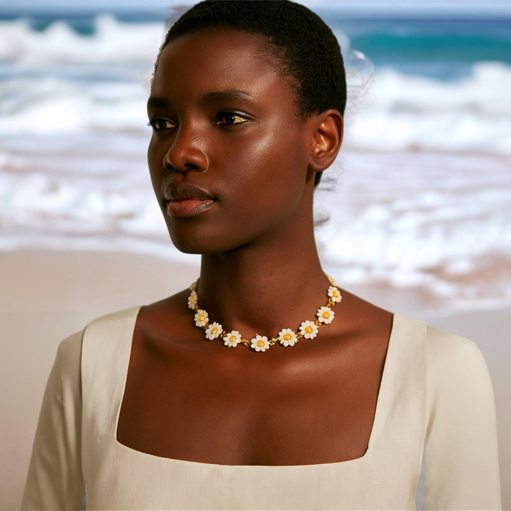 PaulaB Jewellery daisy floral necklace 14k gold plated enamel flowers lifestyle photo on beach Australia New Zealand.
