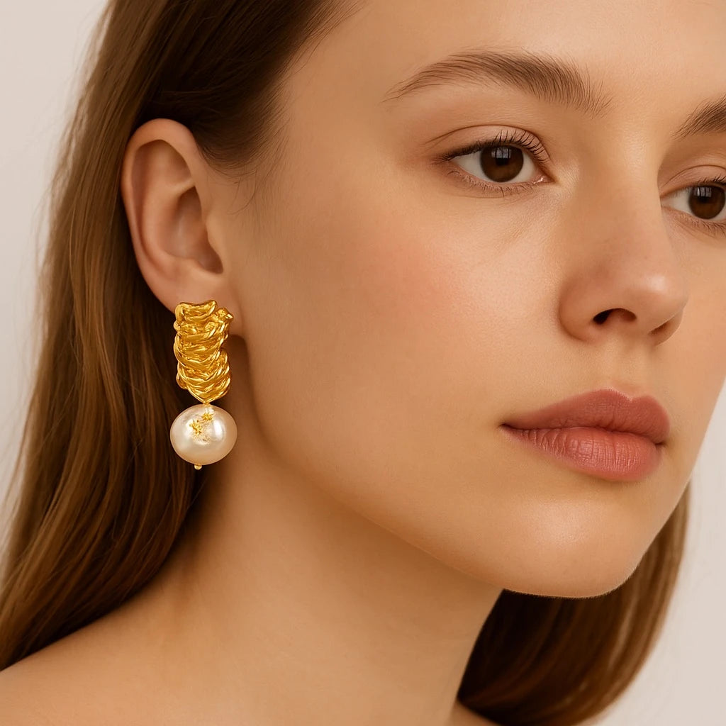 Side view of PaulaB Eclat Perle Earrings sculptural gold and pearl drop earrings in French elegant style. PaulaB Jewellery Australia NZ England.