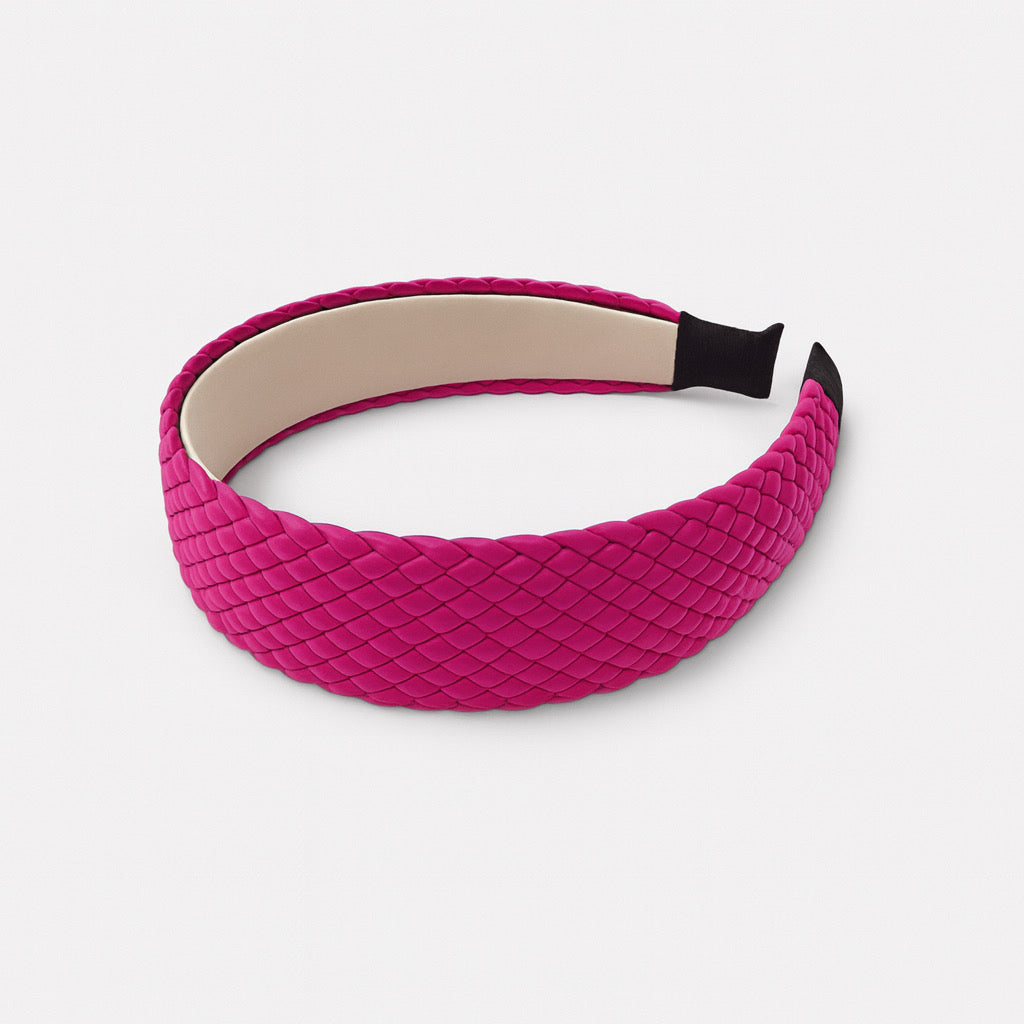 Fuchsia pink woven PU leather headband displayed flat- chic women's hair accessory