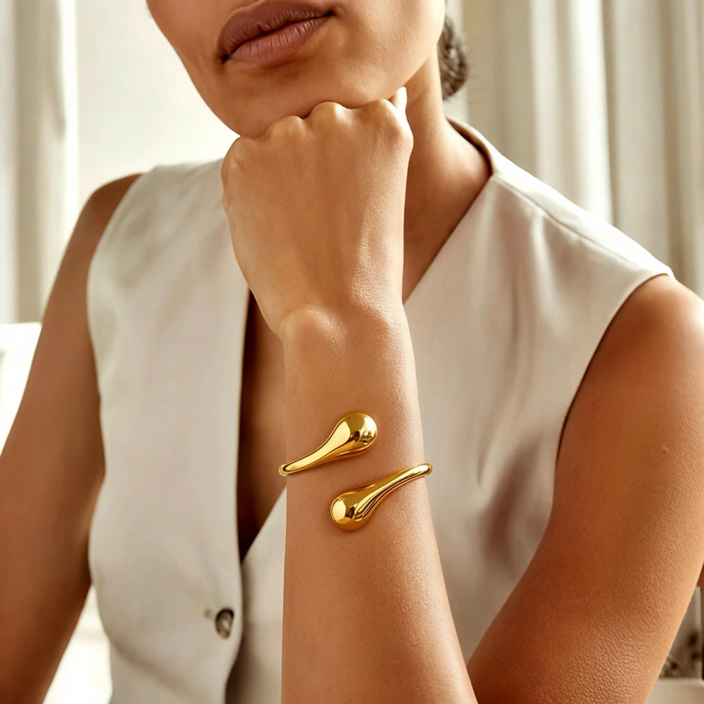 Model wearing PaulaB 18K gold open cuff bracelet, minimalist modern fashion jewellery close-up lifestyle photo for Australia & New Zealand customers. 