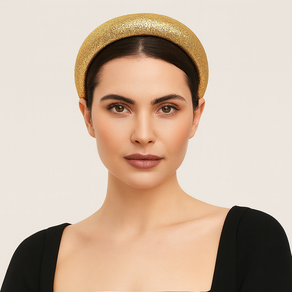 Model wearing PaulaB gold glitter headband in studio closeup elegant style fashion.