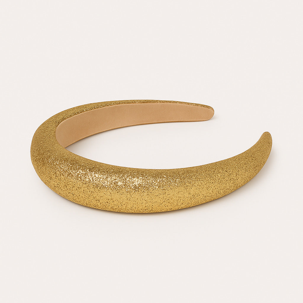 Flat lay of PaulaB gold sparkle headband, soft crown padded design.