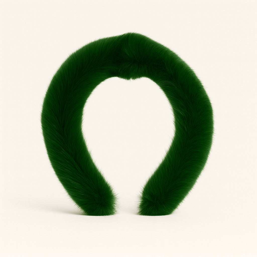 Flat lay of PaulaB rabbit fur headband in emerald green.