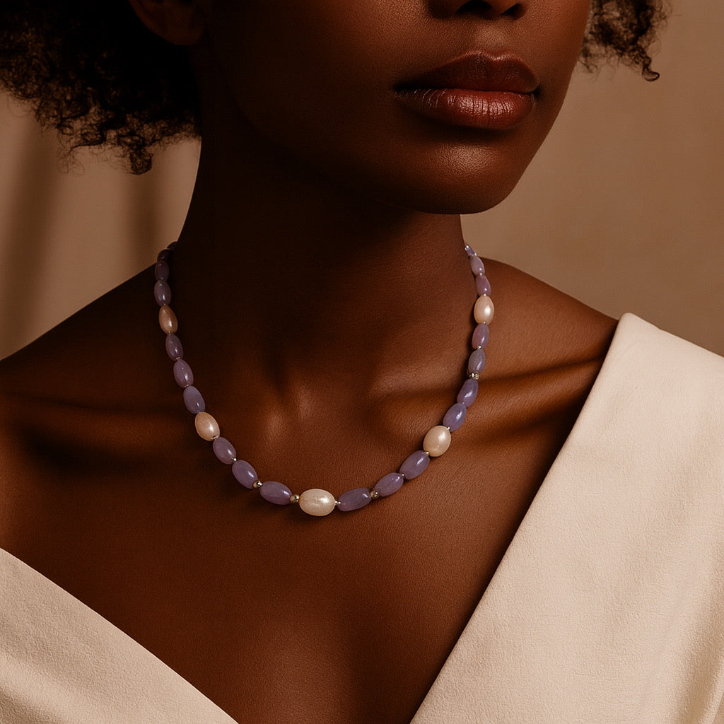 Close-up of model wearing PaulaB lavender purple freshwater pearl necklace with 8k gold plating.