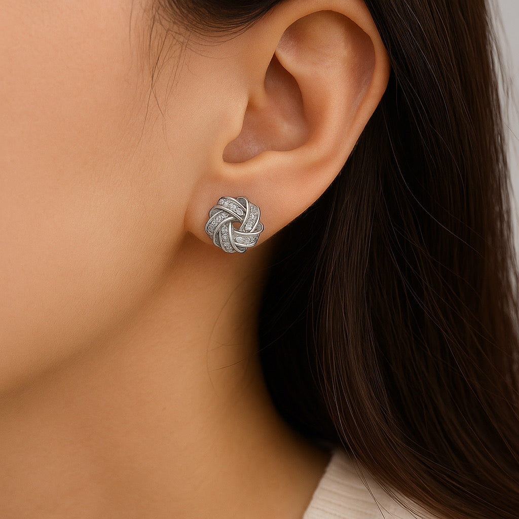 Model wearing rhodium silver love-knot zircon stud earrings close-up 1cm.