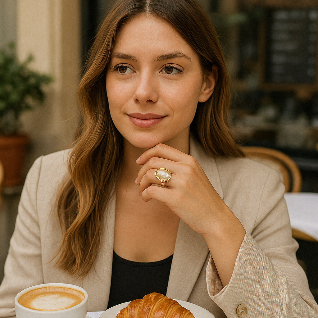 Model wearing PaulaB Lumina Bloom Ring at Paris Cafe style scene - 14k gold-plated pearl ring, Australian jewellery lifestle
