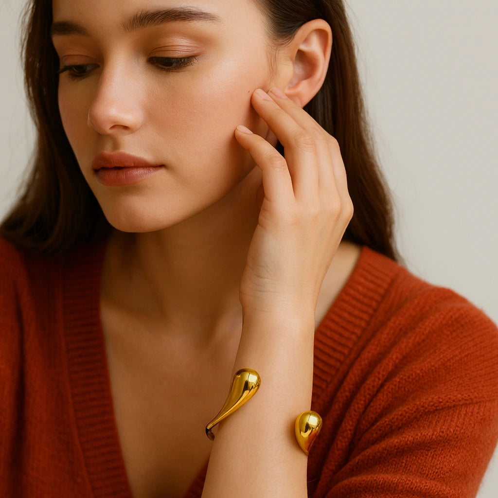 PaulaB modern gold cuff bracelet styled on model, elegant polished 18k finish, minimalist luxury accessory brand based in Australia.