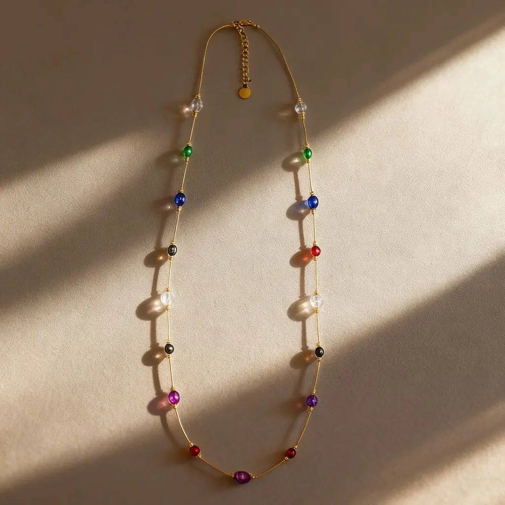 PaulaB 18k gold-plated multi-gemstone necklace flat-lay on white background studio product photo for catalogue.