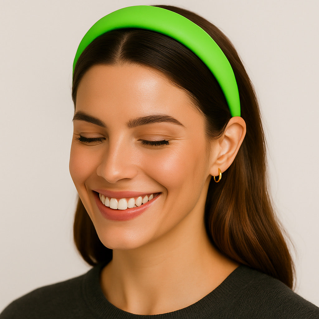 Model smiling while wearing PaulaB neon green PU leather headband