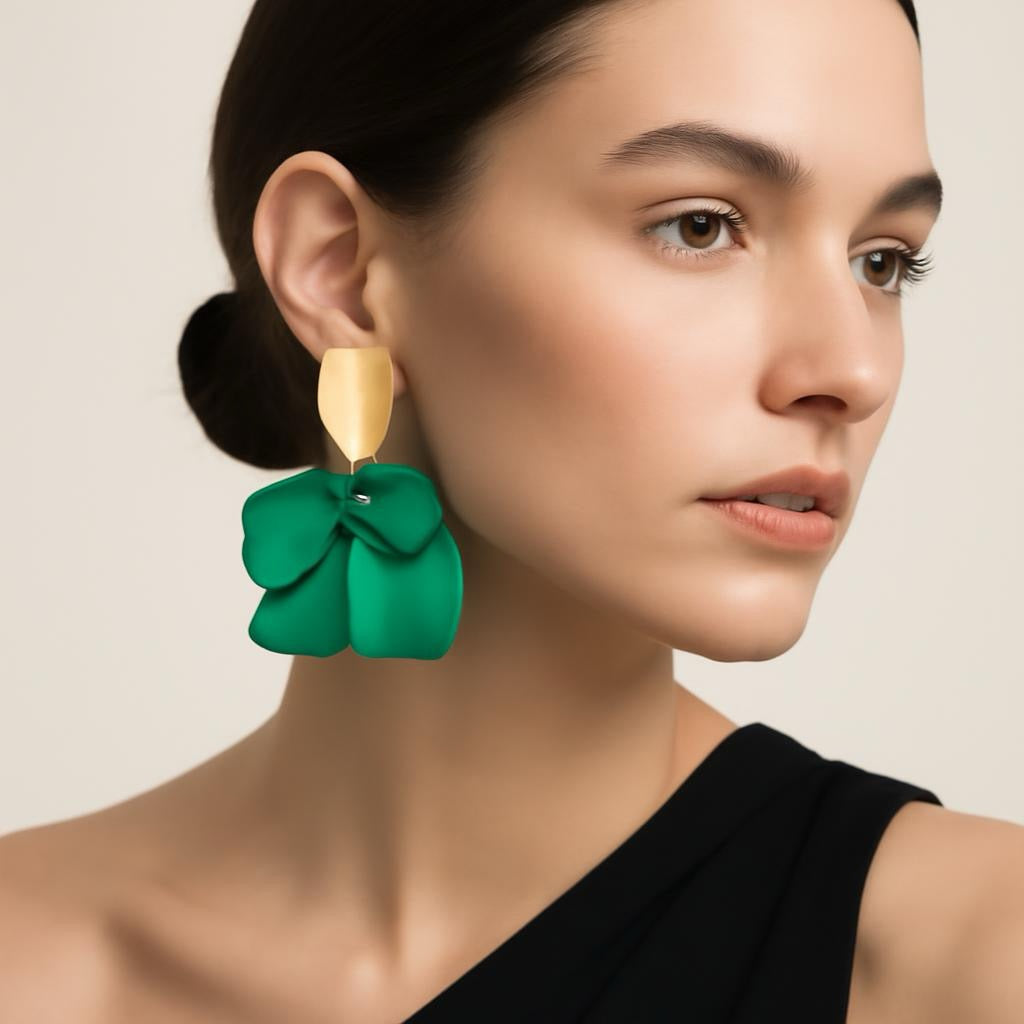 Model wearing emerald green petal statement earrings.
