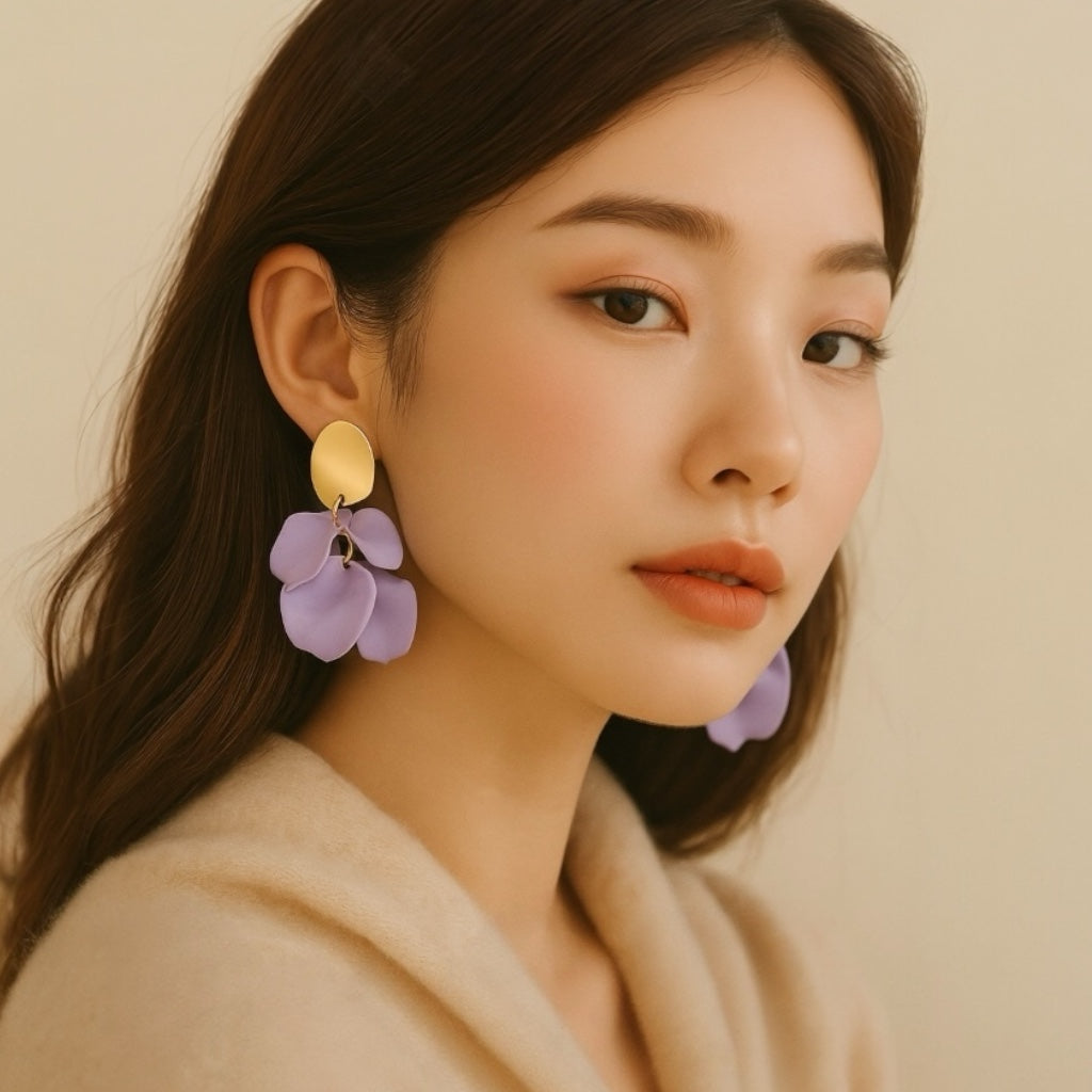 Model wearing lilac petal statement earrings.
