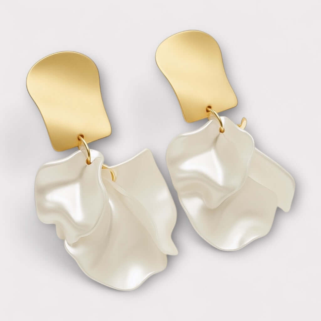 Pearl white lustrous petal statement earrings front view.
