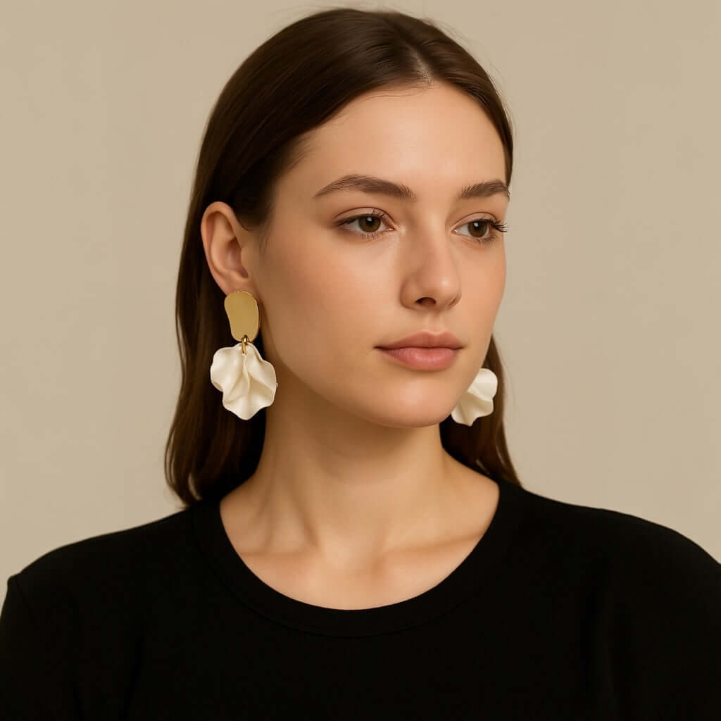 Model wearing pearl white petal statement earrings.

