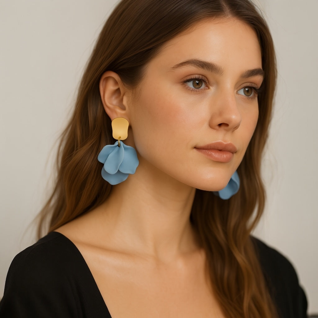 Model wearing sky blue petal statement earrings.