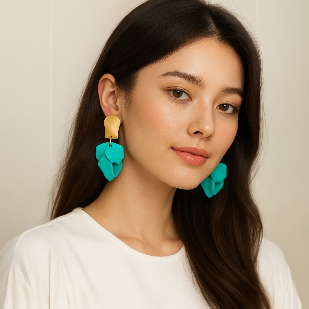 Model wearing teal petal statement earrings
