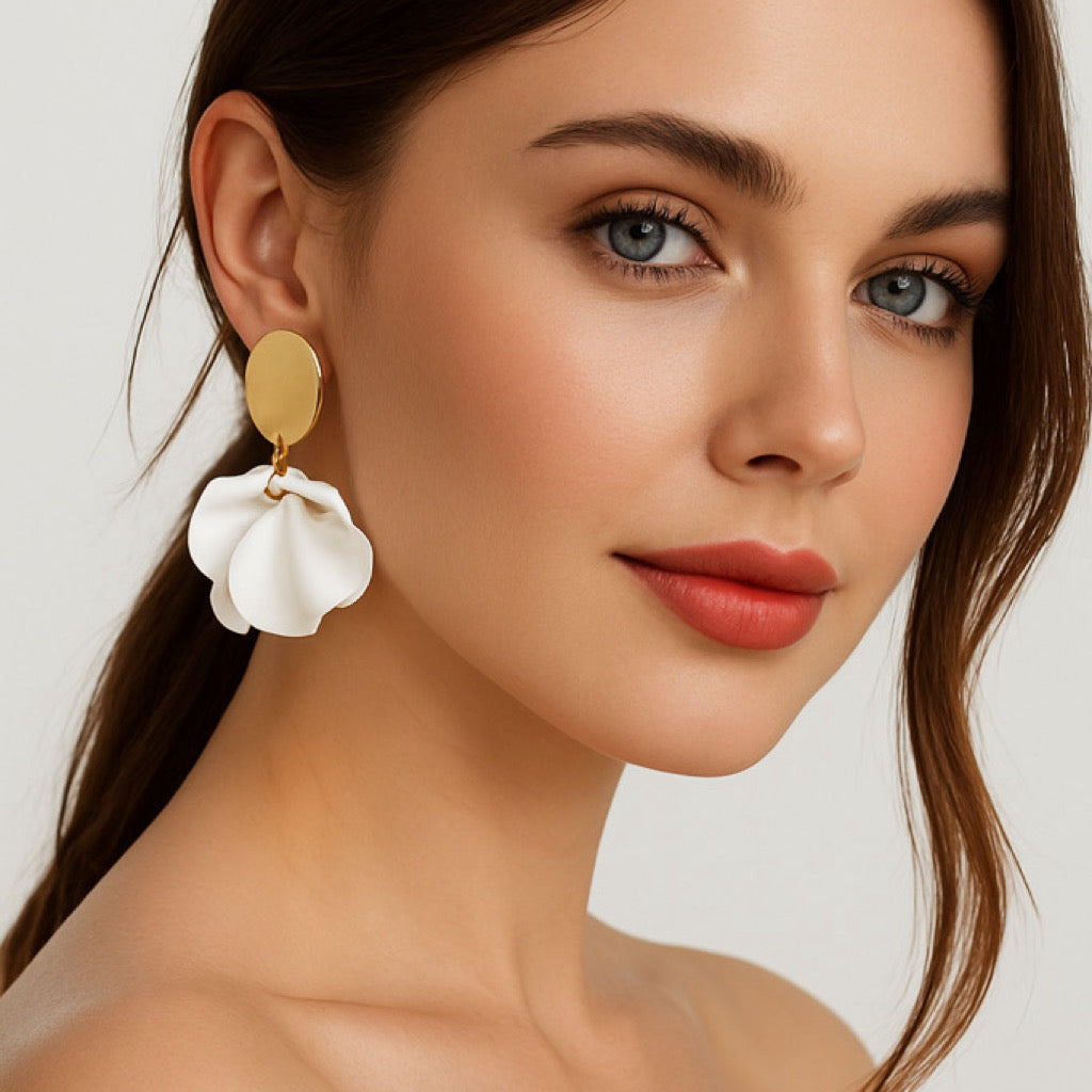 Model wearing white petal statement earrings.
