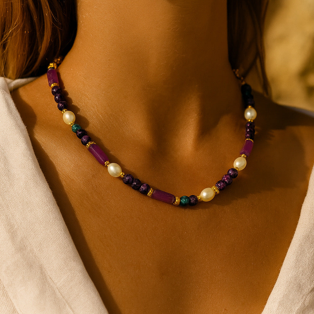Closeup of PaulaB necklace with purple gemstones, pearls and gold accents - elegant Australia New Zealand jewellery.