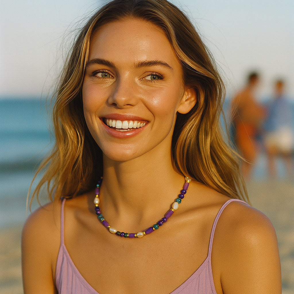 Model wearing PaulaB purple gemstone pearl necklace at the beach - statement jewellery for women in AU NZ accesories.