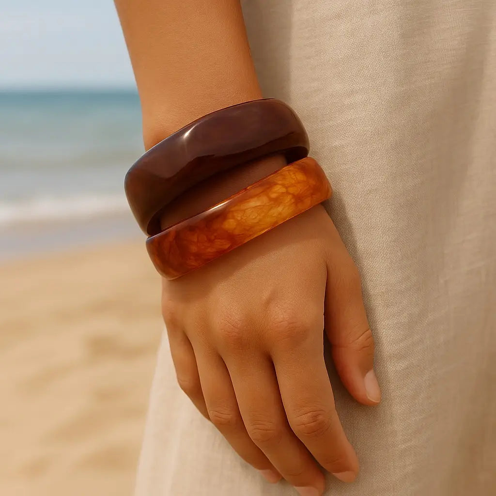 PaulaB Brown and Amber Resin Layering Bangles - model beach close-up, coastal jewellery style for AU NZ UK shoppers.