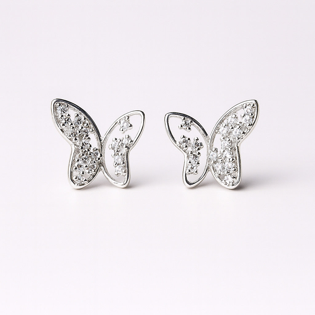PaulaB rhodium plated sterling silver butterfly stud earrings with sparkling cubic zirconia, front display.