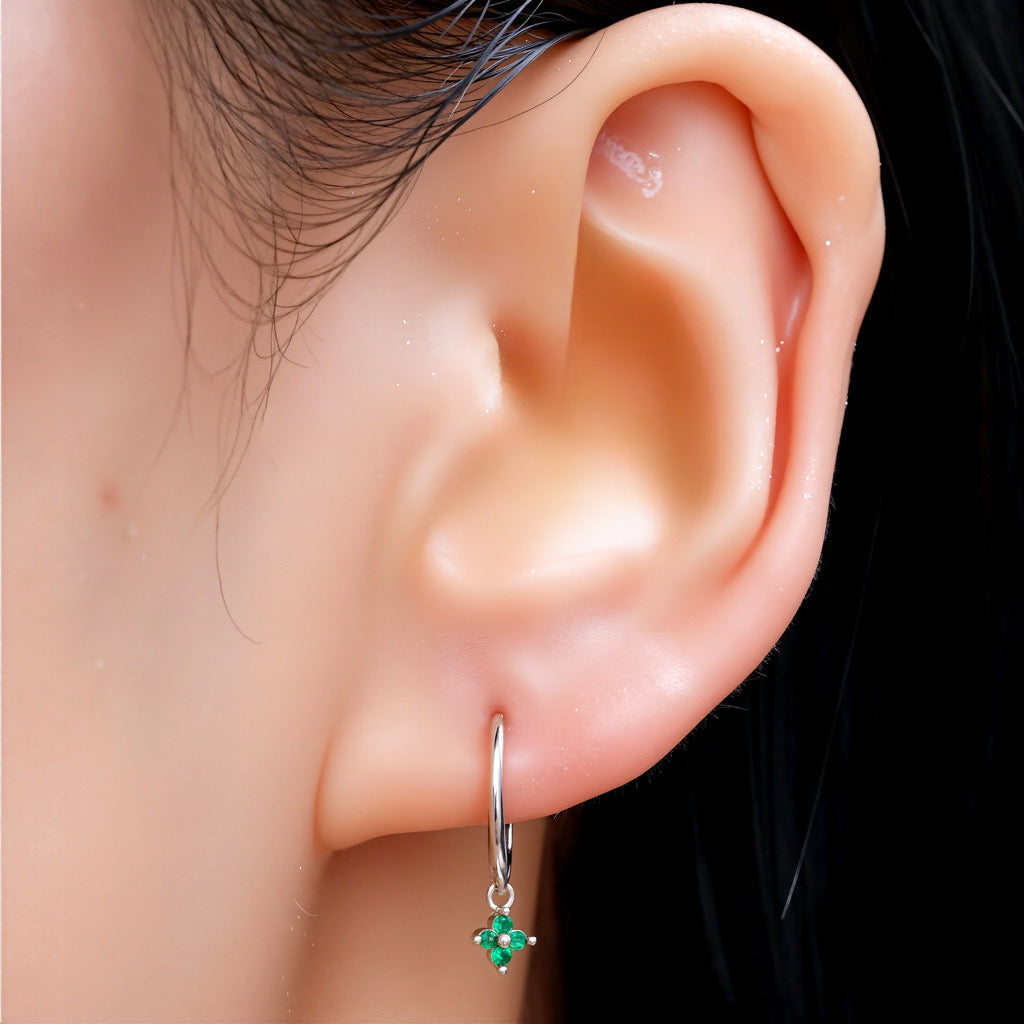 Model showcasing PaulaB sterling silver rhodium hoop earrings with green, emerald gemstone - Sydney jewellery.